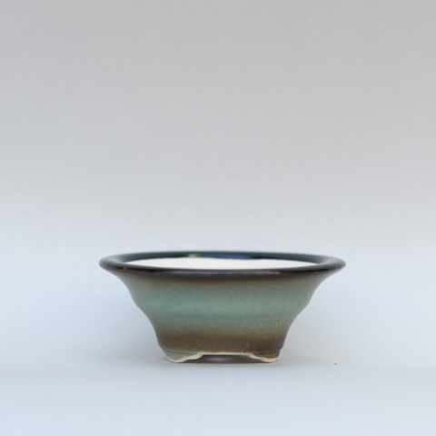 Pale blue flared pot with brown rim