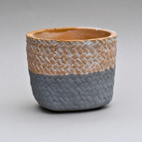 Concrete plant pot with woven fabric pattern