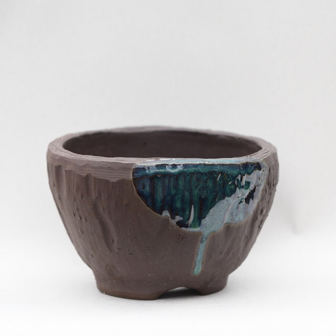 Textured brown bowl pot with shiny blue accent