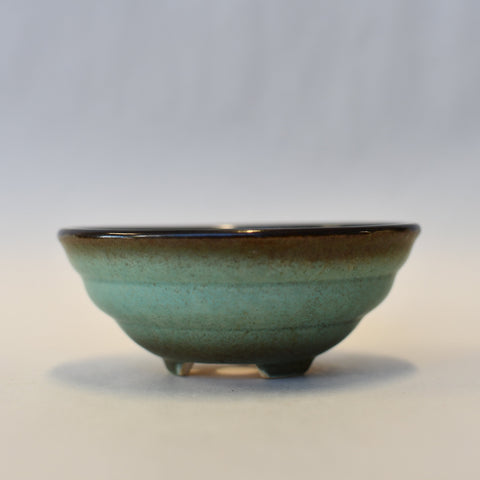 Round turquoise pot with brown rim