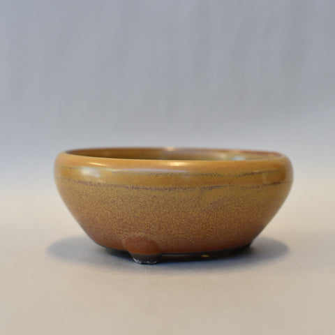 Round yellow and caramel pot
